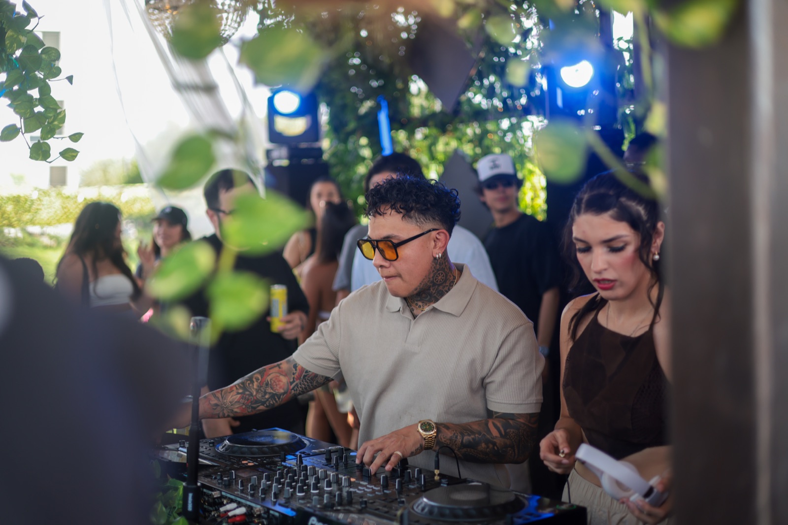 DAVINCII at the decks, framed through greenery at Elsewhere Too